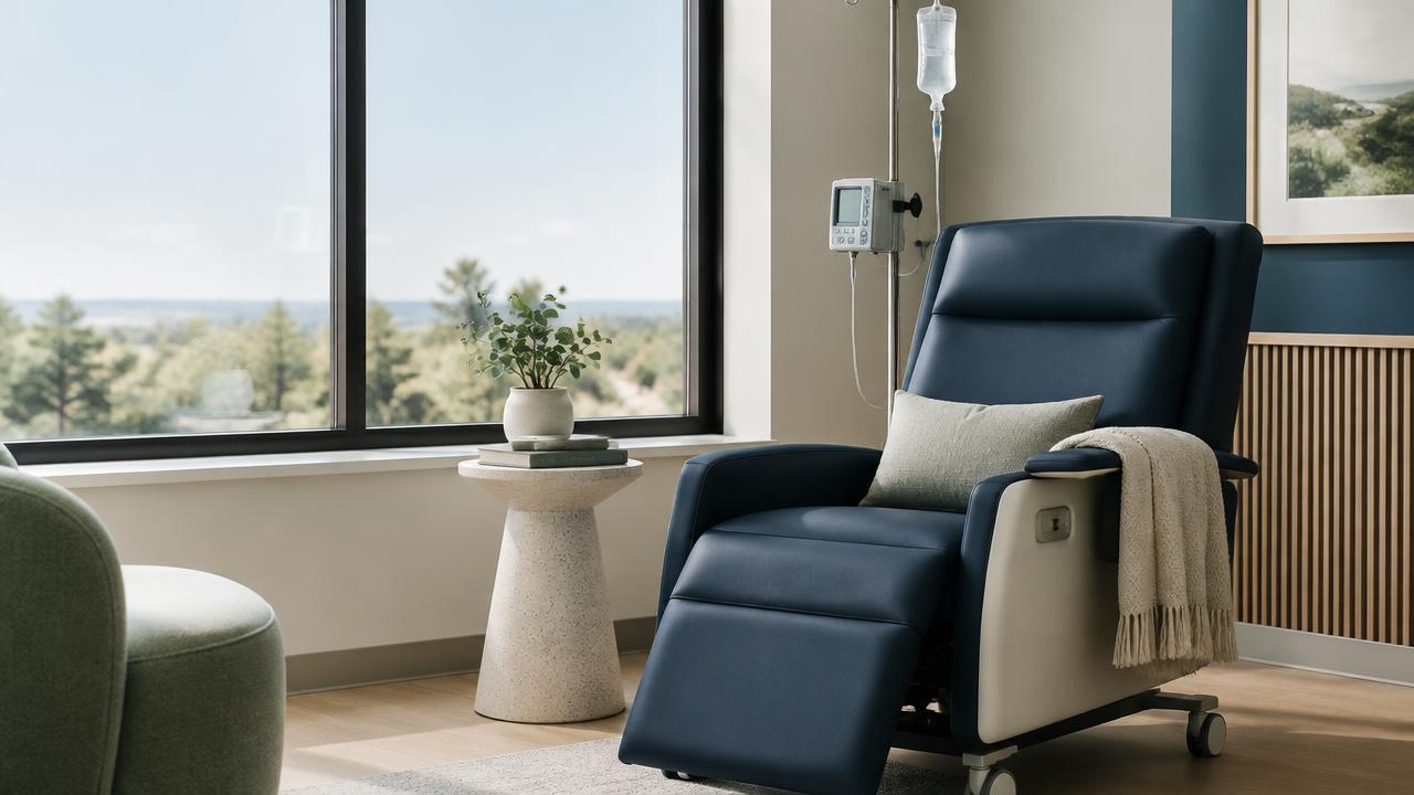 A calm infusion therapy chair by a large window
